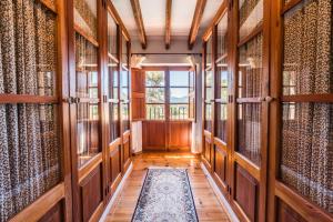 a hallway of a library with wooden doors and a rug at Cas Galgo Luxury Villa in Valldemossa in Valldemossa