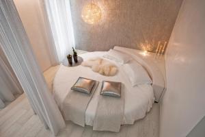 a cat laying on a bed in a room at Villa Kofler Wonderland Resort in Campitello di Fassa