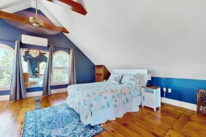 a bedroom with a bed and a blue wall at Longview House in Gloucester