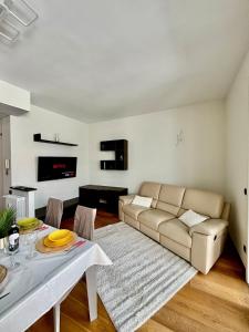 a living room with a couch and a table at Attico del Duomo Historic Center & Free Wi-Fi in Asti