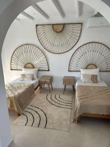 a bedroom with two beds and a rug at Villa Eden Djerba in Djerba +82 photos