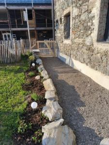a garden with rocks in front of a building at Der SteinStadL in Raumberg