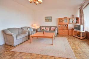 a living room with a couch and a coffee table at FeWo Zeidler Nr42 Sol Mare in Kellenhusen