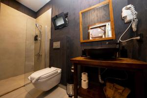 a bathroom with a toilet and a sink and a mirror at Lov Faralya Adults Only in Faralya