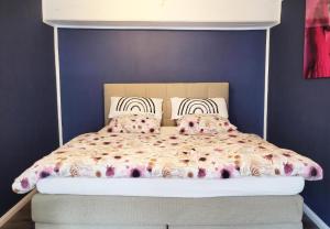 a bed in a bedroom with a blue wall at Stay - you time in Hamburg