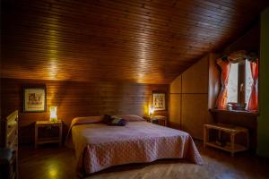 a bedroom with a bed in a wooden room at B&B Pian Savin in Giaveno