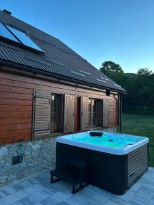 a hot tub on a patio next to a building at Plitvički San in Korenica +37 photos