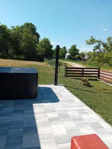 a park with a bench and a wooden fence at Plitvički San in Korenica