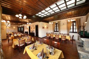 a restaurant with tables and chairs in a room at Hotel Ivanov Konak i Depadans Palac in Cetinje