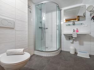 a bathroom with a toilet and a glass shower at Apartment Simonhöhe-1 by Interhome in Sankt Paul
