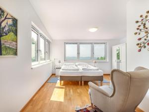 a white room with two beds and a chair at Apartment Maisonette by Interhome in Sankt Paul