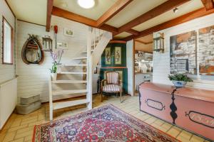 a living room with a staircase and a rug at Naboløs Bed'n Kitchen - Nyborg in Bovense