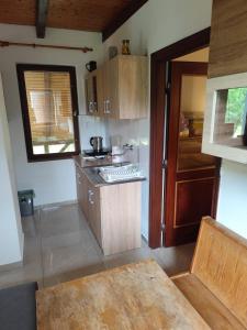 a kitchen with wooden cabinets and a counter top at Balassa Weekendhouse in Siófok +28 photos