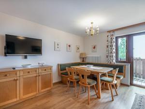 a dining room with a table and chairs and a tv at Apartment Simonhöhe Veitsberg by Interhome in Sankt Paul +31 photos