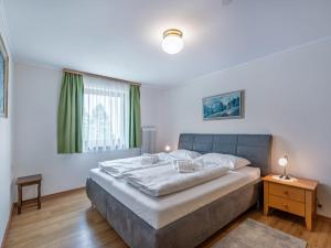 a bedroom with a large bed and a window at Apartment Simonhöhe Veitsberg by Interhome in Sankt Paul