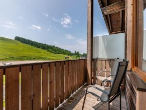 a balcony with two chairs and a view at Apartment Simonhöhe-3 by Interhome in Sankt Paul