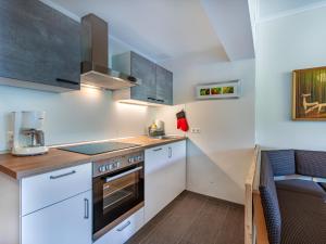 a kitchen with white cabinets and a counter top at Apartment Simonhöhe-3 by Interhome in Sankt Paul