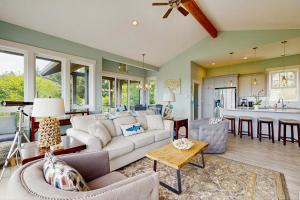 a living room with a white couch and a kitchen at Alta Vista in Pacific City