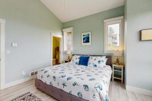 a bedroom with a bed and two windows at Alta Vista in Pacific City