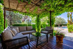 a patio with a couch and a table and chairs at Cas Galgo Luxury Villa in Valldemossa in Valldemossa