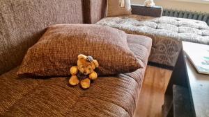 a teddy bear sitting on top of a couch at Stylish Apt, Free Parking, Near Center & Airport in Varna City +32 photos