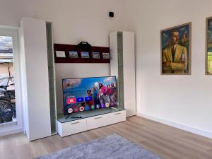 a living room with a flat screen tv in a wall at Ferienhaus Wasserburg in Wasserburg am Bodensee