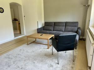 a living room with a couch and a coffee table at Ferienhaus Wasserburg in Wasserburg am Bodensee