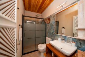a bathroom with a sink and a toilet at Lov Faralya Adults Only in Faralya