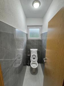 a bathroom with a toilet and a window at Villa Nature Konjic in Konjic
