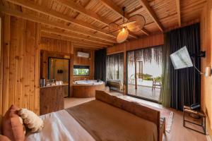 a bedroom with a bed and a bathroom with a tub at Lov Faralya Adults Only in Faralya