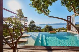 a swimming pool with a view of the water at Lov Faralya Adults Only in Faralya