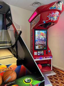 a game room with a basketball arcade and a video game at Hôtel Villa M Marseille in Marseille +50 photos