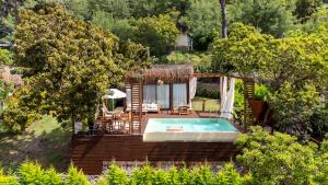a house with a swimming pool in a garden at Lov Faralya Adults Only in Faralya