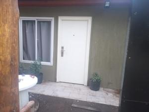 a bathroom with a white door and a sink at cabaña martin in Sierra de la Ventana