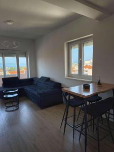 a living room with a blue couch and a table at Apartment Lana in Makarska