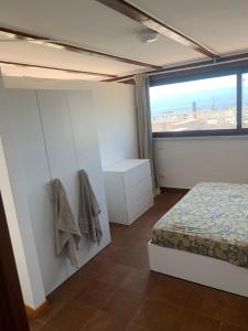 a bedroom with a bed and a large window at luxury ciccy apartment in Reggio di Calabria