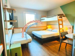 a room with two bunk beds and a desk at ibis budget Rodez in Rodez +47 photos