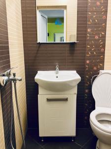 a bathroom with a sink and a toilet at Нашата къща in Sinemorets +22 photos