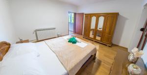 a bedroom with a bed with a green bow on it at Holiday Home Blaz in Ljubuški