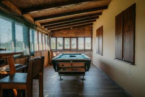 a room with a pool table in the middle of it at Ruralna kuća za odmor - Bitunjac in Levanjska Varoš