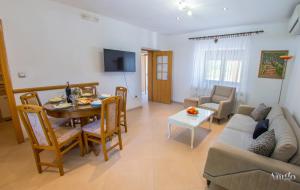 a living room with a table and a couch at Holiday Home Blaz in Ljubuški