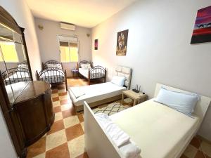a living room with two beds and a couch at Hassan host Housse in Er Rachidia +84 photos