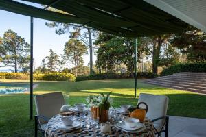 a table under a tent with a table and chairs at To live happily live outside surrounded by nature in Estoril