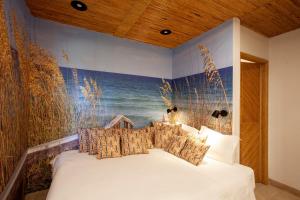 a bedroom with a bed with a painting on the wall at To live happily live outside surrounded by nature in Estoril