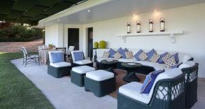 a patio with a couch and chairs and a table at To live happily live outside surrounded by nature in Estoril +6 photos
