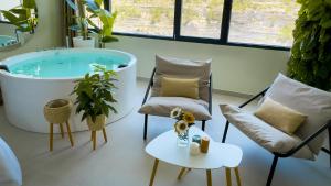 a bathroom with a tub and two chairs and a table at Panorama Suites in Jorquera