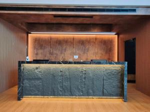 a conference room with a green wall and a table at Well Garden Hotel in Taoyuan