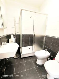 a bathroom with two sinks and a shower and a toilet at Amber apartment in Palanga +10 photos