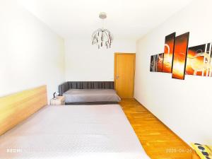 a room with a bed and a chandelier at Amber apartment in Palanga