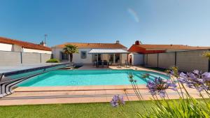 a swimming pool in the backyard of a house at Palm Cornue avec piscine privative in Saint-Gilles-Croix-de-Vie